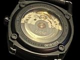 a close up of a watch on a black background