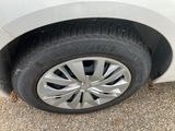 a close up of a tire on a white car