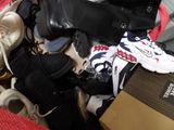 a pile of shoes and a box on the floor