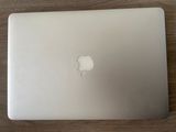 an apple laptop computer sitting on top of a wooden table