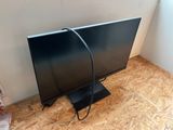 a picture of a flat screen tv sitting on a wooden floor