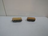 two toy buses that are sitting on a table