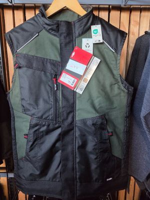 men ' s vests and jackets hanging on a rack in a store