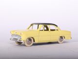 yellow toy car on white surface with white background