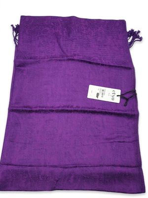 un sac violet muni d'une étiquette, posé sur une surface blanche