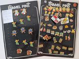 two posters on the wall with pins attached to them