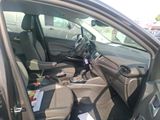the interior of a car with the door open and the driver ' s seat down