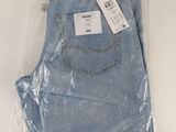 the back of a pair of light blue jeans wrapped in plastic