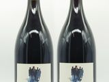deux bouteilles de vin posées l'une à côté de l'autre sur une surface blanche