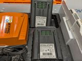 two batteries and a charger in a box