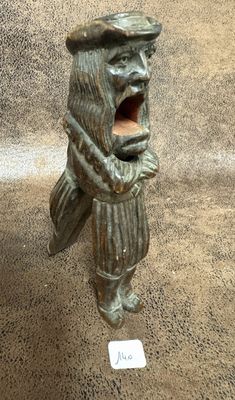 a statue of a man with a hat and a bag