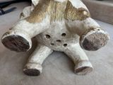 a white and gold elephant sitting on a bed
