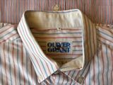 striped shirt with blue, red, and white stripes and a logo on the chest