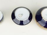 two blue and white bowls sitting next to each other