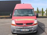 a red van that is parked in a parking lot