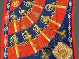 red, blue and gold scarf with a picture of a necklace and a purse