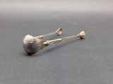 pair of silver spoons on a gray surface