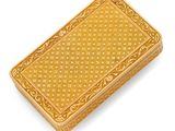 an antique gold cigarette case on a white background
