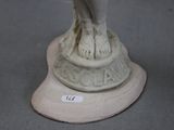 a statue of a woman holding a bird on top of a pedestal