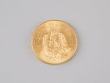 an image of a gold coin sitting on top of a white surface