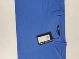 a blue polo shirt with a tag on it