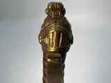 a close up view of a gold sword with a clock on it