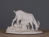 a statue of a cow and a calf on a table