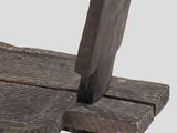 a wooden chair that has a wooden seat on it