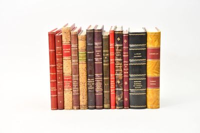 several books are stacked on top of each other on a white surface
