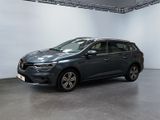 the grey car is parked in a large room with white walls