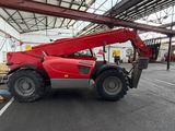 a red crane that is parked inside of a building