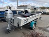 a boat that is parked next to a boat trailer