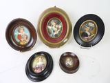 four miniature plates with pictures of people on them sitting on a table