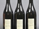 three bottles of wine sitting on top of a table next to each other