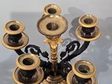 a black and gold candelab with six candles on it