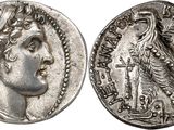 a silver coin with an image of a woman and a bird on it