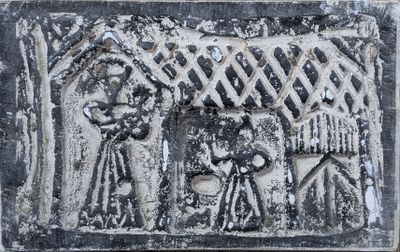 an image of a stone plaque with a picture of a man and a woman