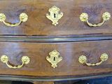 a wooden dresser with gold handles and a drawer
