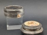 an image of a small silver box with a lid and a small silver box with a lid