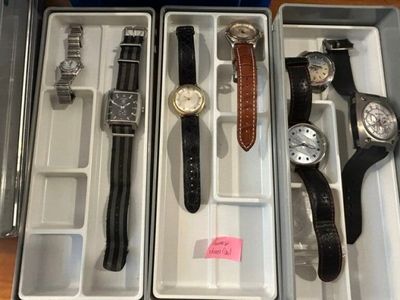 many different watches in the box on the table