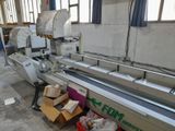 a machine that is working on boxes in a factory