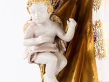 a figurine of a child holding a baby