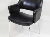 a black leather chair with chrome legs on a white background