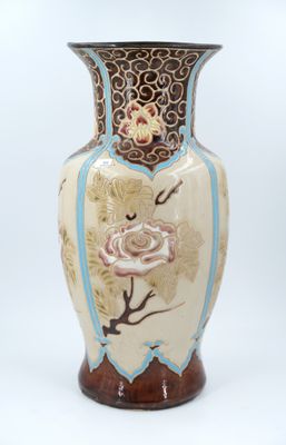 a vase with a rose on it sitting on a table