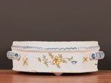a white bowl with blue and yellow designs on it