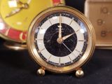 a clock that is sitting on a table next to other clocks