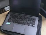 three laptops sitting on a desk in a room