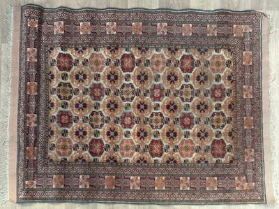 Tapis à décor de rosaces en damier dans un entourage de fris…