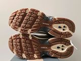 the soles of a pair of running shoes on top of a box