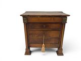 an old wooden dresser with a broom sitting on top of it